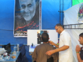 An Arba'in pilgrim gets free shave and a smile from Qasim Soleimani on the road from Najaf to Karbala.